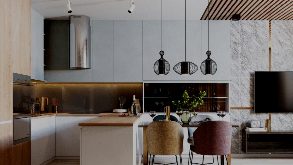 a wood-accented island with two upholstered bar stools, pendant lights with black wire-frame shades, and a stone-textured wall with a mounted flat-screen TV."